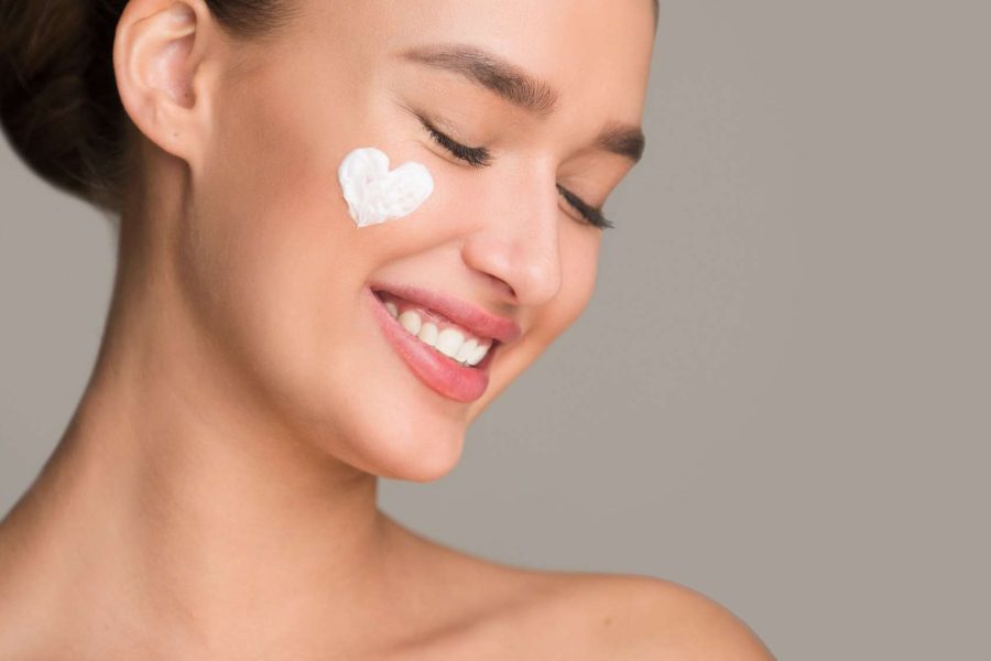 Anti wrinkle cream. Woman with cream in heart shape